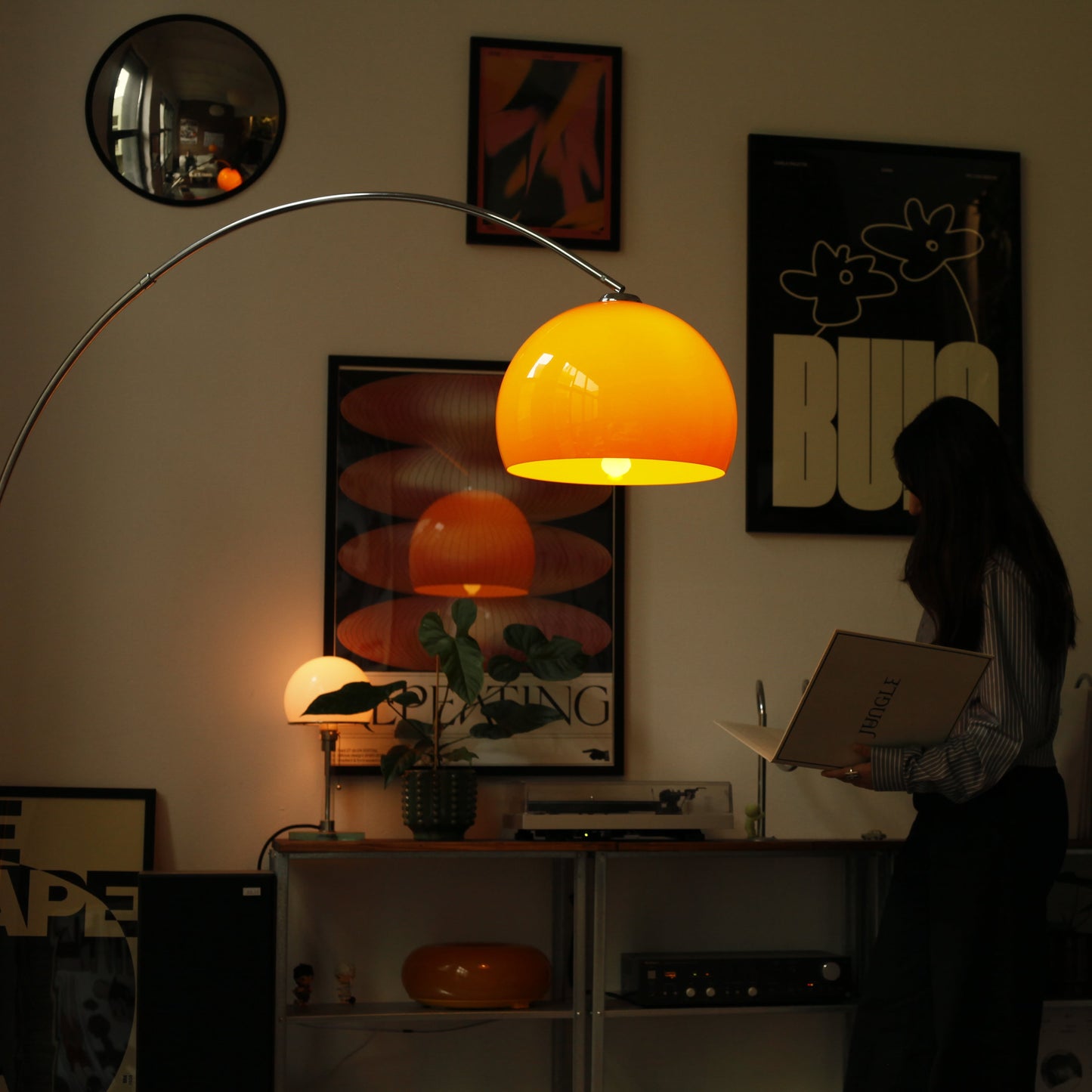 Orange Arch Lamp styled beside reading nook with warm lighting